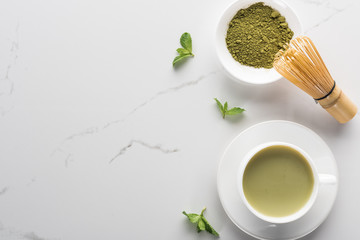top view of green matcha tea with mint on white table