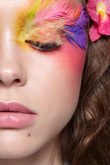 Close-up  shot of female face. Woman with bright stylish eyes make-up and false fashion feather eyelashes 
