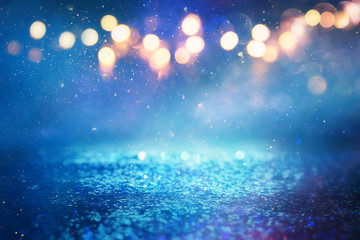 background of abstract glitter lights. blue, gold and silver. de focused