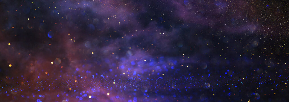 background of abstract glitter lights. blue, purple and black. de focused. banner © tomertu