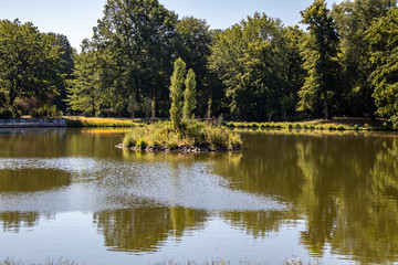 View of an idyllic park landscape in Leipzig,Germany with a pond with island