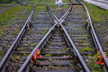Railway arrow close-up with rails and sleepers