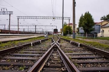 Railway arrow close-up with rails and sleepers