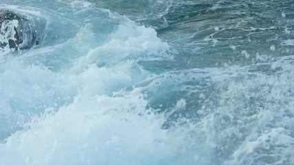 Slow motion sea waves crashing. Close-up shot.