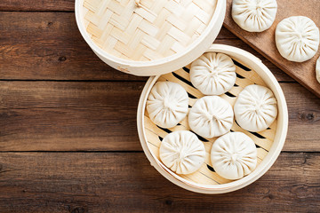 Raw dumplings Dim Sum in bamboo steamer. 