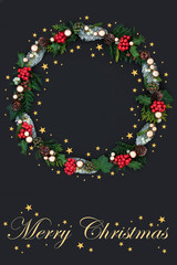 Festive Merry Christmas wreath with gold stars, winter flora and fauna and gold bauble decorations on dark grey background with title. Traditional festive theme with title.