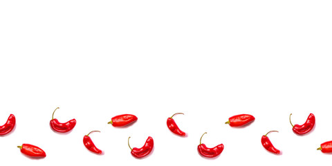A lot of red hot chili peppers on a white background.