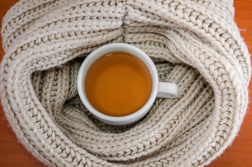 cup of tea in a scarf. View from above. Close-up.
