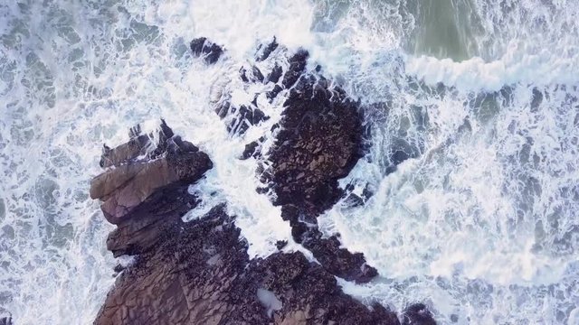 Waves crashing on to a rocky shoreline