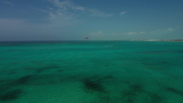 Aerial Drone Video of people parasailing over the exotic caribbean sea