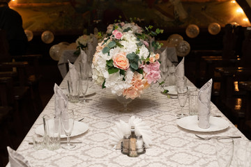 a bouquet of flowers in vase on served tables at the wedding. banquet concept