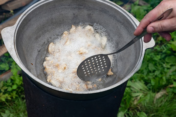 The process of cooking pilaf in a cauldron