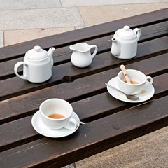 Used crockery on a table outside a cafe
