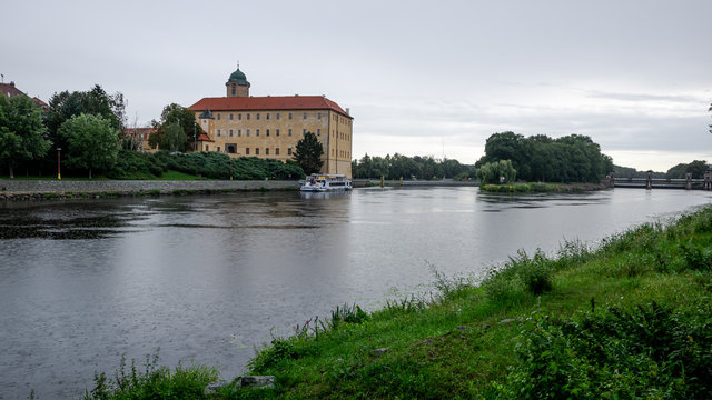 Castle by the river during the light shower in Podebrady town