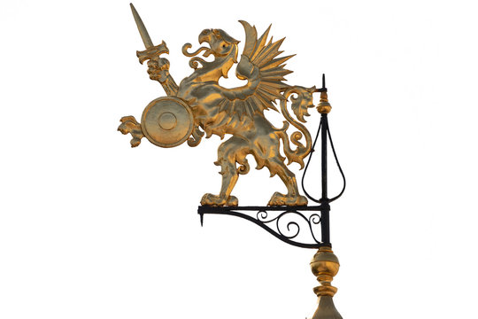 Gold griffin weather vane on green tower