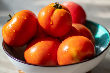 Fresh tomatoes in a plate with drops of water