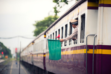 Train officials signal green flags for trains in Bangkok, Thailand, trains to transport people from the train station into the capital