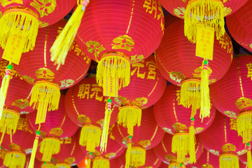 Lucky Chinese red paper lanterns and yellow tails with the written Chinese word