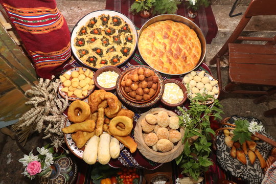 Freshly baked homemade bread arranged in traditional Bulgarian textiles. Image of some tasty Home-made bakery products. Fresh bread,brown, wheat, sliced, round, product, bagel, delicious, baking.