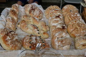 Freshly baked homemade bread arranged in traditional Bulgarian textiles. Image of some tasty Home-made bakery products. Fresh bread,brown, wheat, sliced, round, product, bagel, delicious, baking.