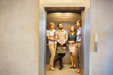 Business people standing in elevator