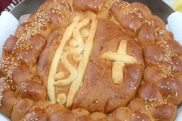 Freshly baked homemade bread arranged in traditional Bulgarian textiles. Image of some tasty Home-made bakery products. Fresh bread,brown, wheat, sliced, round, product, bagel, delicious, baking.