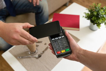 Customer making wireless or contactless payment using smartphone, nfc payment