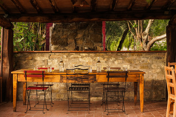 Fototapeta na wymiar table and chairs in rustic italian outdoors