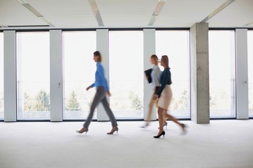 Fototapeta na wymiar Business people walking in office corridor