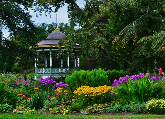 Fototapeta na wymiar Colorful Painted Gazebo Rotunda among Flower Beds at the Halifax Public Gardens Halifax Nova Scotia Canada