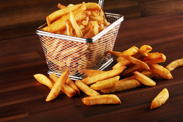 Tasty french fries potato on wooden table background