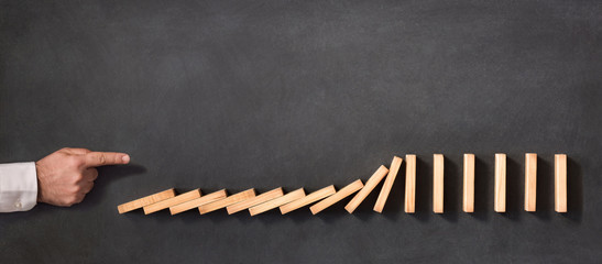 Domino Effect and Business Challenge Concept on Blackboard
