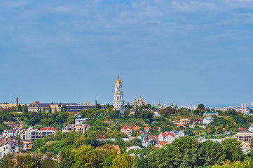 Fototapeta premium Lavra bell tower and Lavra orthodox church and monastery (UNESCO World Heritage 527) on golden sunset against Kyiv city, 2010 September 16, Kyiv (Kiev), Ukraine