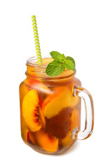 peach iced tea in a glass jar with mint leaves, summer soft drink isolated on white background
