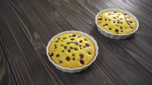 Berry biscuit mini tarts in a baking dish. Tasty dessert with currants. Dark wooden background. Refocuse Twice