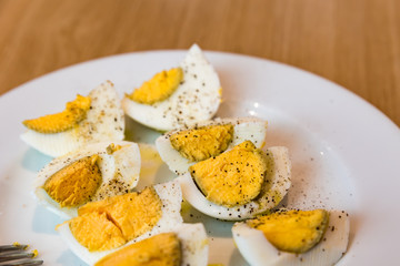 Boiled eggs with salt pepper and olive oil