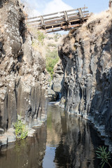 A  bridge over the small canyon with Hexagons River leading to Hexagons Pool on the Golan Heights in Israel