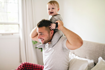 Fototapeta premium A Father with cute baby son on bed at home