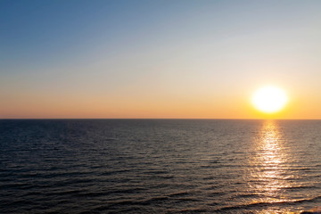 Evening sunset on the sea. The sun almost touched the horizon.
