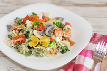 Italian colorful bow tie farfalle pasta with sauce.