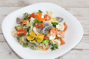 Italian colorful bow tie farfalle pasta with sauce.