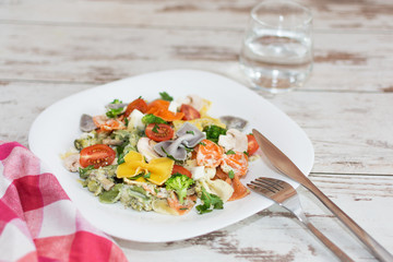 Italian colorful bow tie farfalle pasta with sauce.