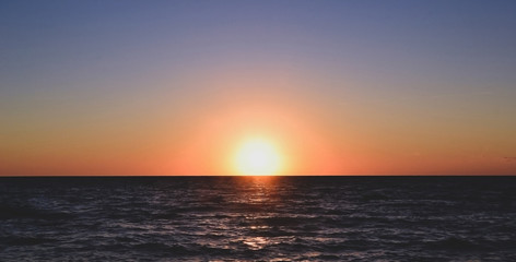 Panorama of beautiful sunset on the ocean.