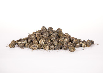 Black dry tea leaves isolated on white background