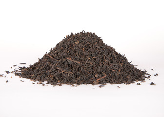 Black dry tea leaves isolated on white background