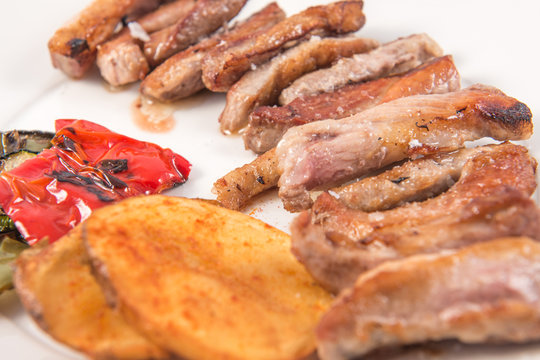 Grilled Secreto of Spanish Iberico pork cut with potatoes and grilled vegetables