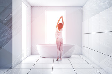Woman in minimalistic white tile bathroom