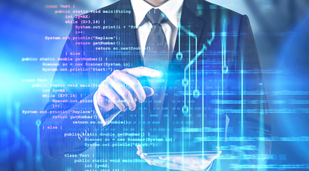 Man with tablet working with code interface