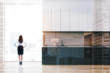 Fototapeta na wymiar Woman in minimalist kitchen with countertops