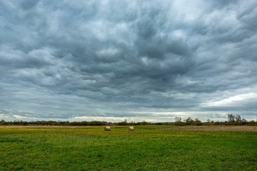 Dark rainy clouds over the meadow